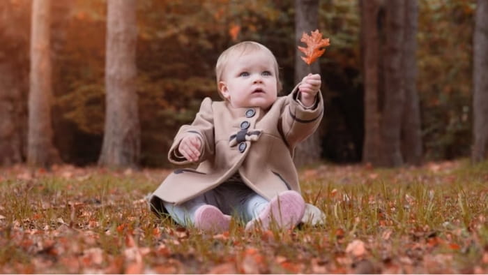 Baby holding a leaf